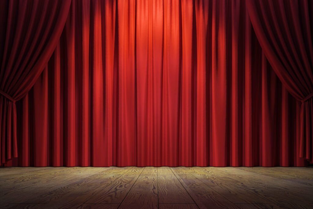 caso Sergio Denis: escenario de teatro con telón rojo y reflector