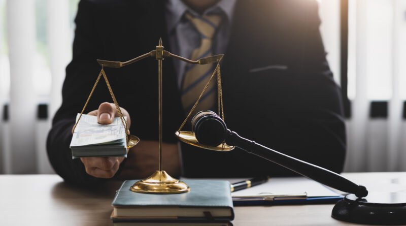 denuncias contra Caputo: mazo de juez junto a billetes sobre un escritorio