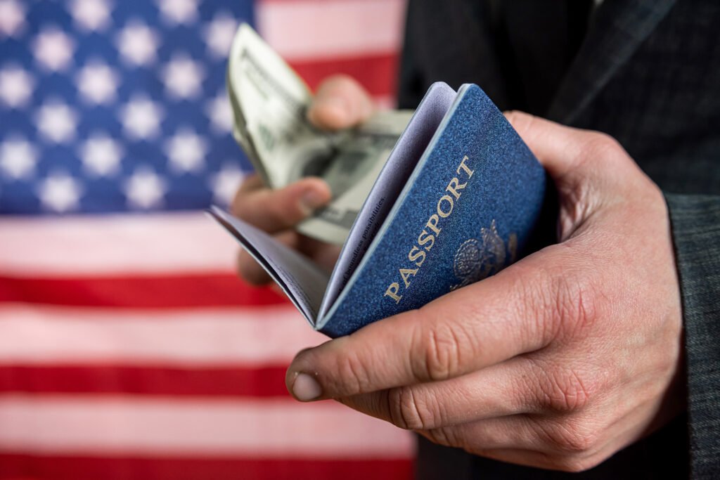 pasaporte dorado: pasaporte junto a billetes de dólar