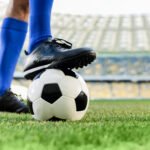 retiro de Messi: piernas de un futbolista con medias celestes junto a la pelota