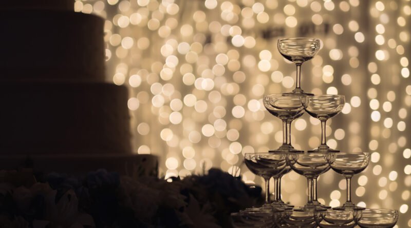 boda de Lali: copas de champán en una fiesta de casamiento con luces cálidas