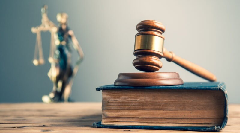 juicio por Maradona: martillo de juez y balanza de la justicia sobre el escritorio