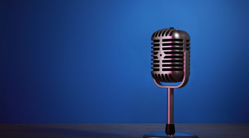 Oscar González Oro: micrófono retro sobre fondo oscuro en homenaje a la radio