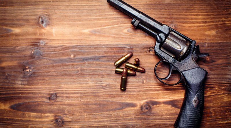 Pepita la Pistolera: pistolas antiguas sobre fondo de madera, estética noir