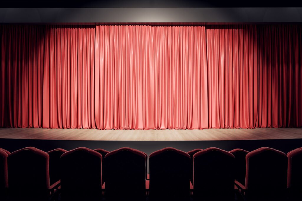 Premios ACE: escenario de teatro con telón rojo y butacas vacías