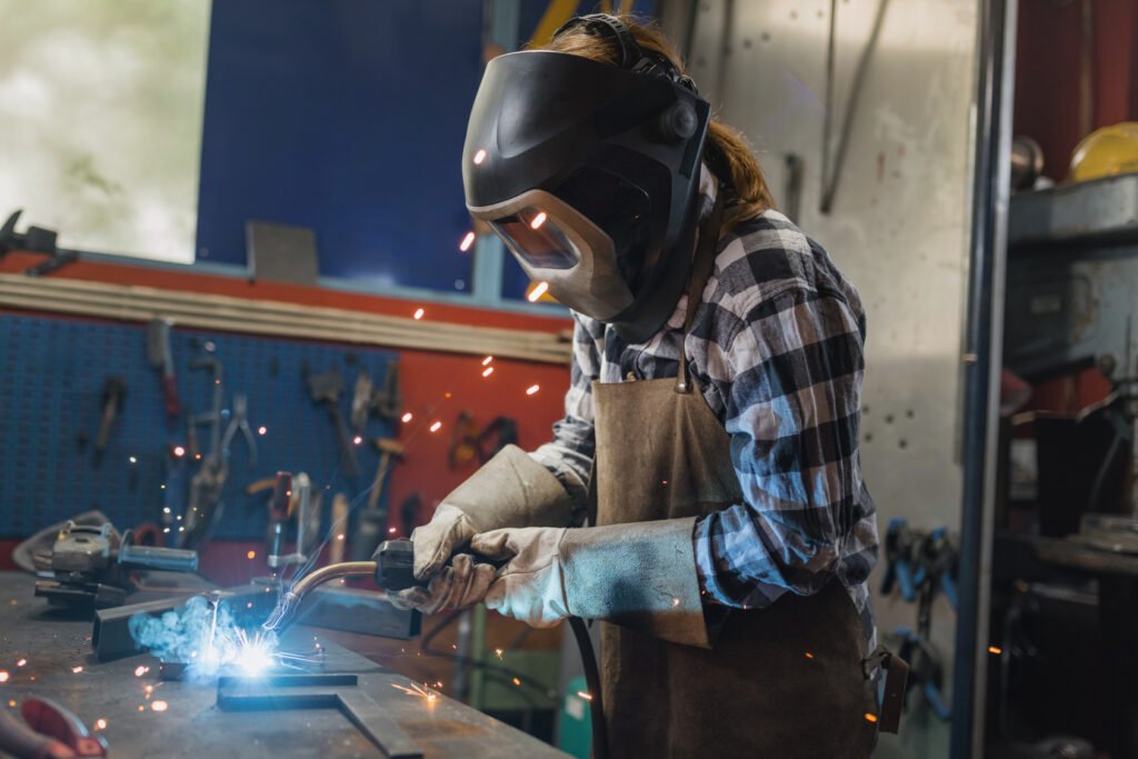 empleo en la industria: operaria soldando en un taller metalúrgico
