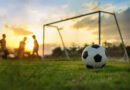 vuelta de la Promoción: partido de fútbol en una cancha al atardecer